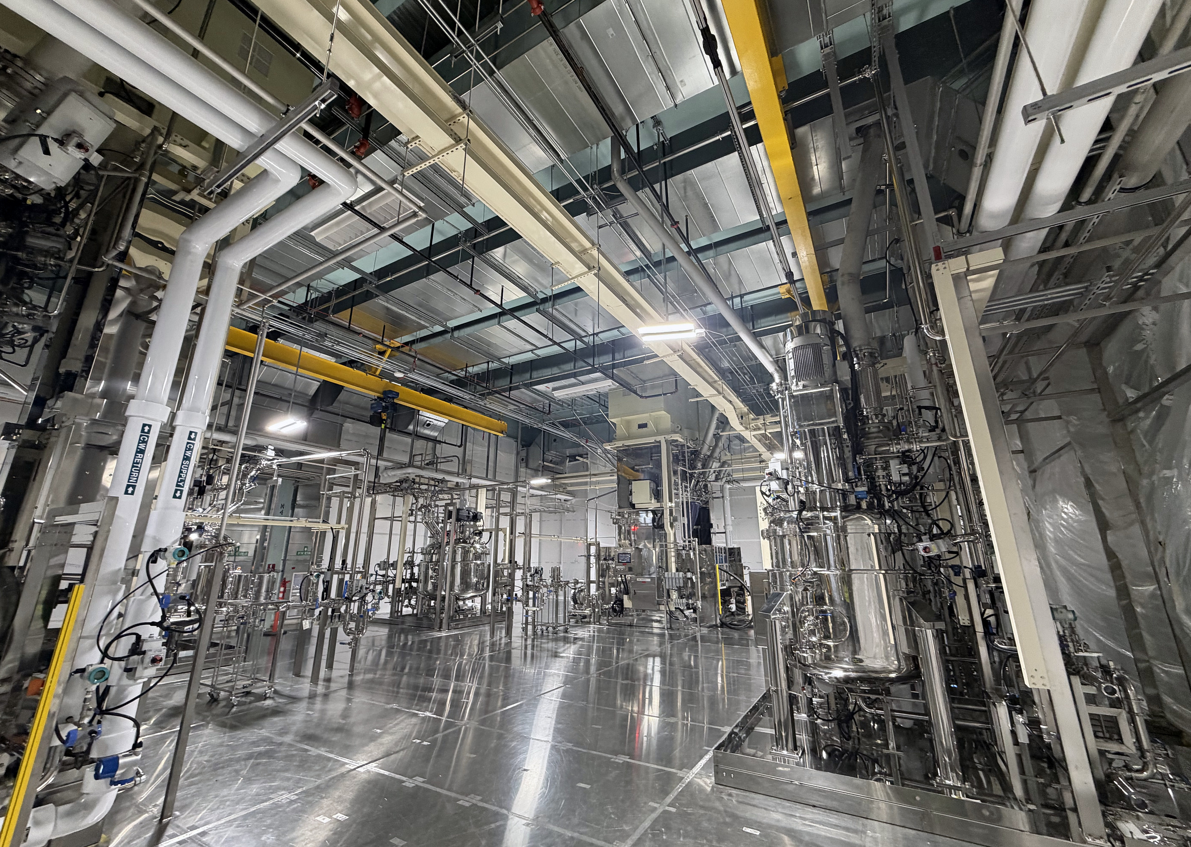 Advanced manufacturing process equipment and industrial utility systems inside a large-scale facility.